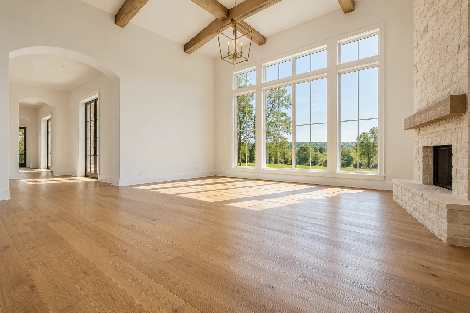 Sunlight fills a clear, open living room with natural wood floors